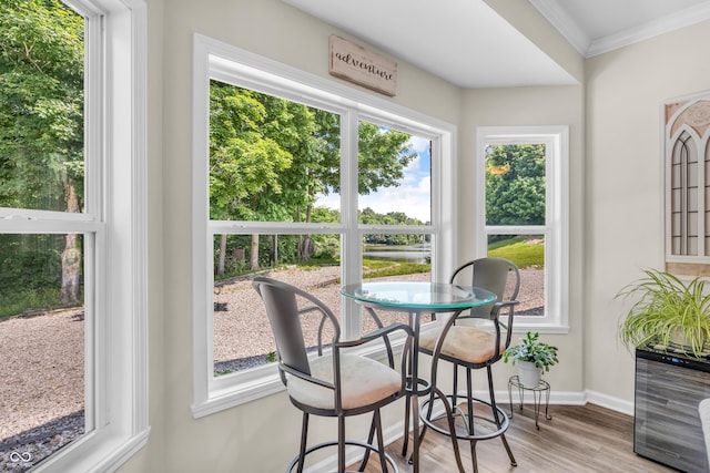 9231 E Poynter Dr, Morgantown, IN 46160 - dining room featuring crown molding, wood finished floors, and a water view
