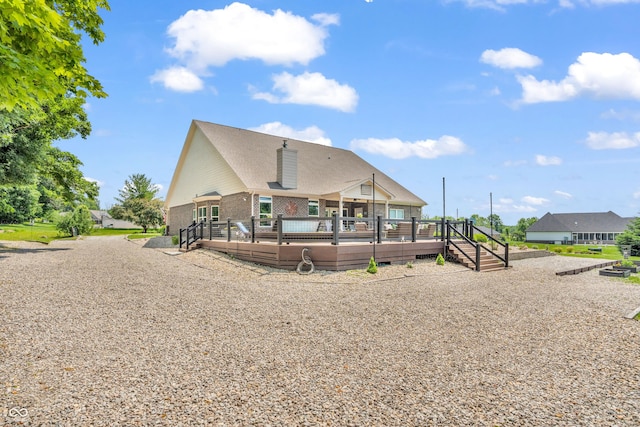 9231 E Poynter Dr, Morgantown, IN 46160 - rear view of property featuring a deck, brick siding, and a chimney
