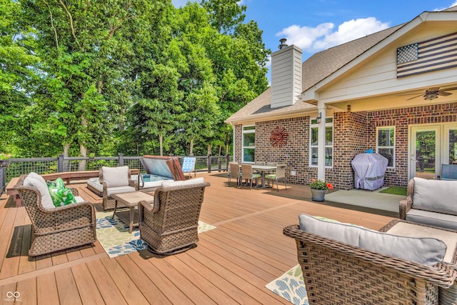 9231 E Poynter Dr, Morgantown, IN 46160 - wooden terrace with an outdoor living space, area for grilling, outdoor dining area, ceiling fan, and view of scattered trees