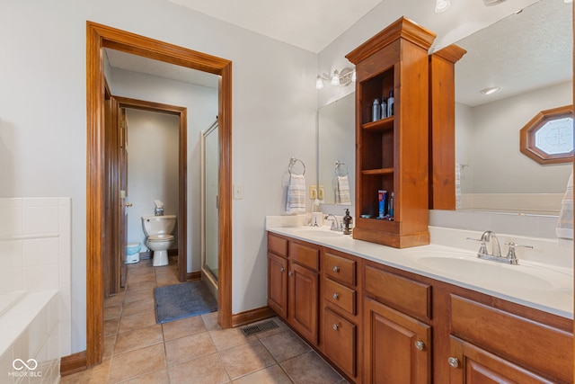 6629 Woodcrest Dr, Avon, IN 46123 - bathroom with tile patterned floors, double vanity, a shower stall, a bathtub, and a bidet