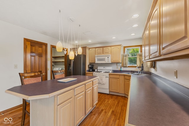 6629 Woodcrest Dr, Avon, IN 46123 - kitchen featuring white appliances, light brown cabinets, a breakfast bar area, light wood-type flooring, and recessed lighting