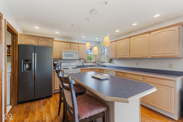 6629 Woodcrest Dr, Avon, IN 46123 - kitchen featuring white appliances, light brown cabinetry, light wood-type flooring, a center island, and recessed lighting