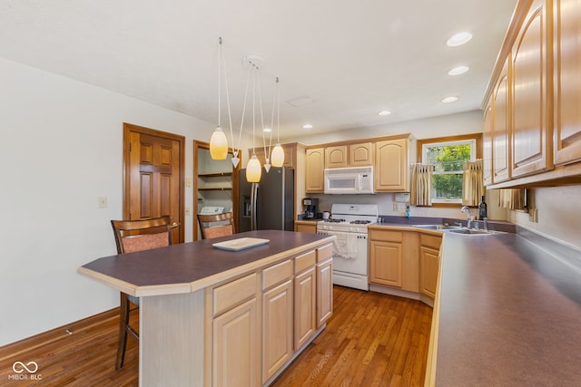 6629 Woodcrest Dr, Avon, IN 46123 - kitchen featuring white appliances, light brown cabinetry, a kitchen bar, a kitchen island, and light wood finished floors