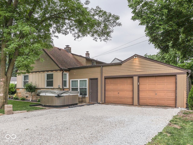 1532 E Markwood Ave, Indianapolis, IN 46227 - rustic home with a hot tub, a chimney, an attached garage, and driveway