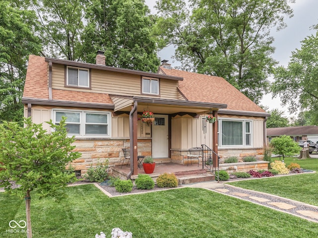 1532 E Markwood Ave, Indianapolis, IN 46227 - view of front of house featuring a chimney, a front yard, stone siding, roof with shingles, and board and batten siding