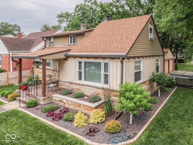 1532 E Markwood Ave, Indianapolis, IN 46227 - view of front of home with a chimney, a hot tub, stone siding, a patio, and roof with shingles