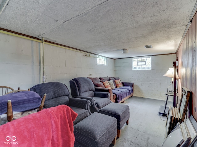 1532 E Markwood Ave, Indianapolis, IN 46227 - living area with unfinished concrete floors, concrete block wall, and a textured ceiling
