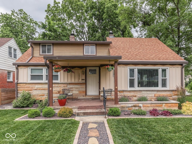 1532 E Markwood Ave, Indianapolis, IN 46227 - view of front of house featuring a chimney, stone siding, board and batten siding, and a front yard