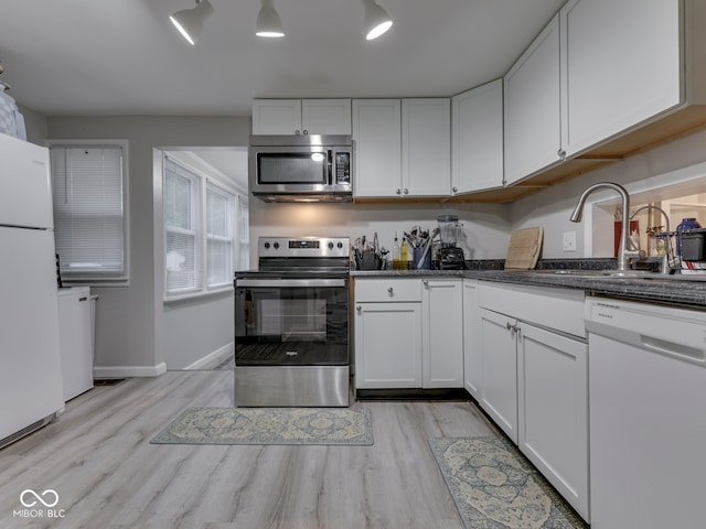 1532 E Markwood Ave, Indianapolis, IN 46227 - kitchen featuring stainless steel appliances, light wood-style floors, and white cabinetry
