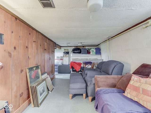 1532 E Markwood Ave, Indianapolis, IN 46227 - living area with concrete floors, concrete block wall, and wooden walls