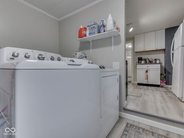 1532 E Markwood Ave, Indianapolis, IN 46227 - laundry area featuring light wood-style floors, washer and clothes dryer, and ornamental molding
