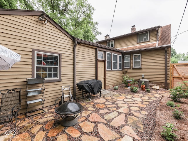 1532 E Markwood Ave, Indianapolis, IN 46227 - rear view of property featuring a fire pit, a patio, and a chimney