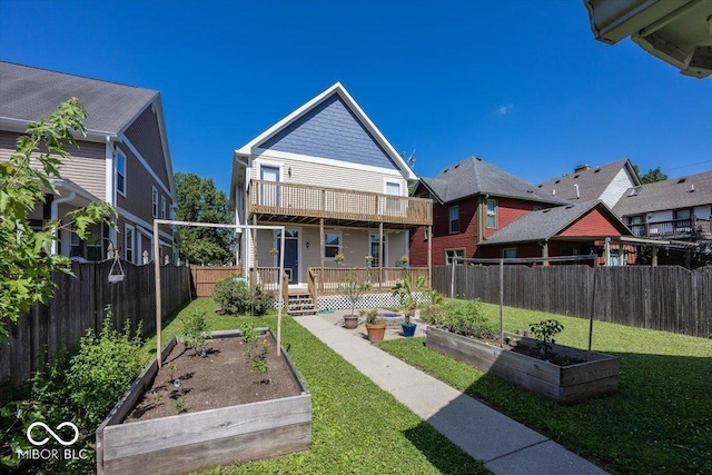 2325 N Talbott St, Indianapolis, IN 46205 - rear view of house featuring a garden, a fenced backyard, a wooden deck, and a balcony