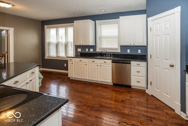 2325 N Talbott St, Indianapolis, IN 46205 - kitchen with dishwasher, dark countertops, dark wood-style flooring, white cabinets, and a textured ceiling