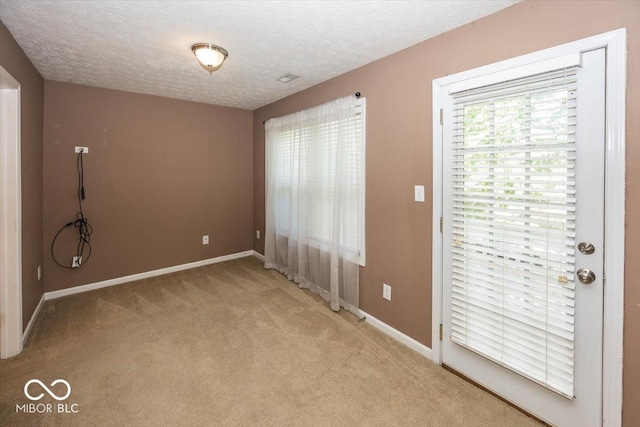 2325 N Talbott St, Indianapolis, IN 46205 - unfurnished bedroom featuring light colored carpet and a textured ceiling