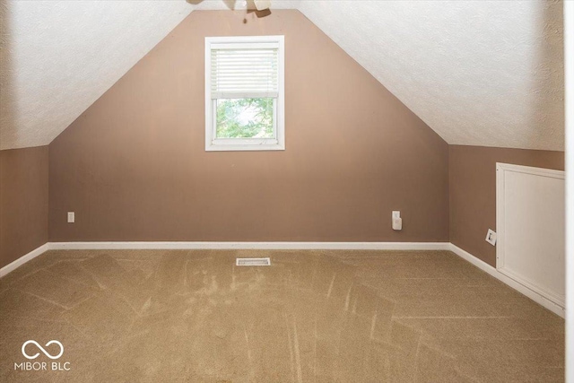 2325 N Talbott St, Indianapolis, IN 46205 - additional living space with carpet flooring, vaulted ceiling, ceiling fan, and a textured ceiling