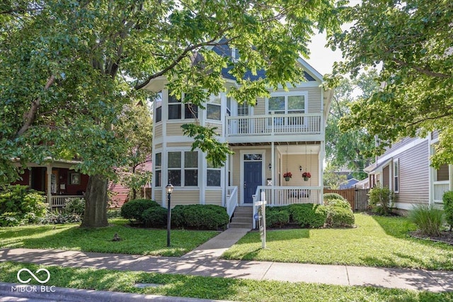 2325 N Talbott St, Indianapolis, IN 46205 - multi unit property featuring a porch, a front yard, and a balcony