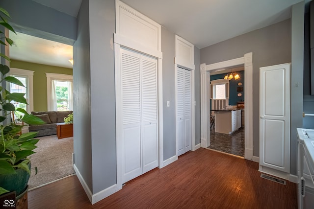 426 N Franklin St, Greensburg, IN 47240 - corridor featuring dark wood-type flooring and a chandelier