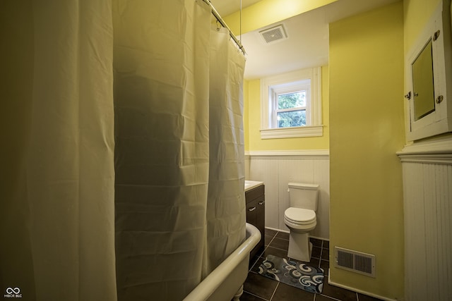 426 N Franklin St, Greensburg, IN 47240 - bathroom with tile patterned floors, a wainscoted wall, a shower with curtain, a tub to relax in, and vanity