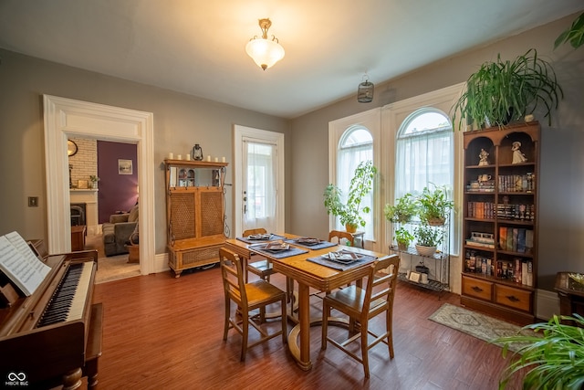 426 N Franklin St, Greensburg, IN 47240 - dining room with healthy amount of natural light, dark wood-style flooring, and a large fireplace