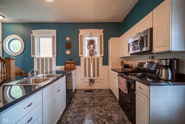426 N Franklin St, Greensburg, IN 47240 - kitchen with black appliances, dark countertops, a textured ceiling, white cabinets, and decorative backsplash