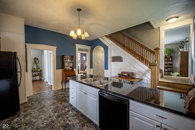 426 N Franklin St, Greensburg, IN 47240 - kitchen featuring black appliances, dark countertops, arched walkways, a textured ceiling, and white cabinetry