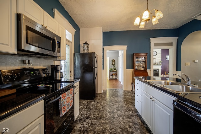 426 N Franklin St, Greensburg, IN 47240 - kitchen with black appliances, arched walkways, white cabinetry, a chandelier, and a textured ceiling