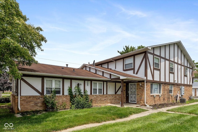 10016 Penrith Dr, Indianapolis, IN 46229 - english style home featuring a front lawn, stucco siding, brick siding, and board and batten siding