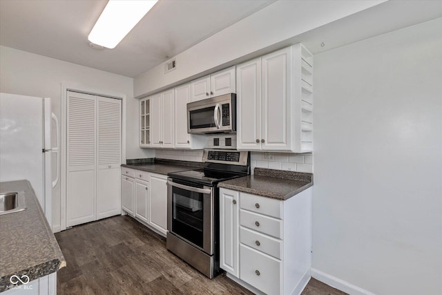 10016 Penrith Dr, Indianapolis, IN 46229 - kitchen featuring stainless steel appliances, dark countertops, and dark wood-style floors