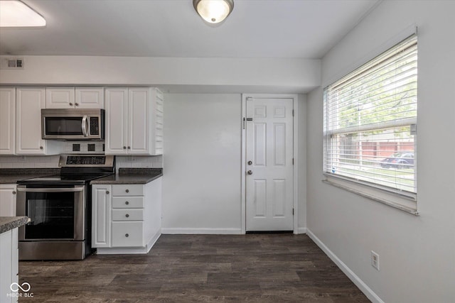10016 Penrith Dr, Indianapolis, IN 46229 - kitchen with stainless steel appliances, dark countertops, backsplash, and white cabinetry