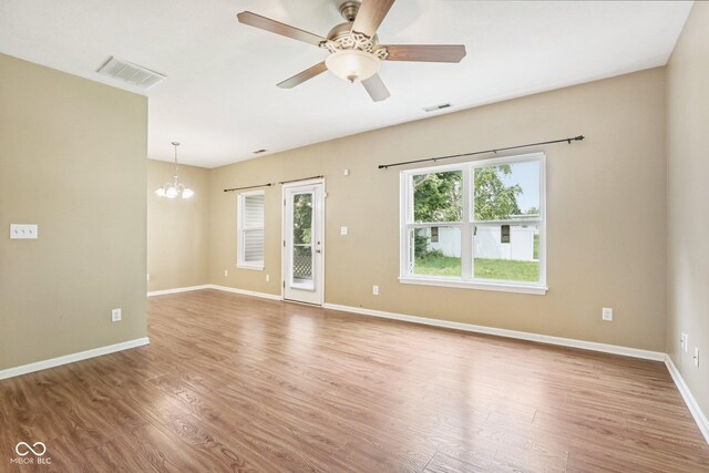 1138 Topp Creek Dr, Indianapolis, IN 46214 - spare room featuring a chandelier, wood finished floors, and ceiling fan