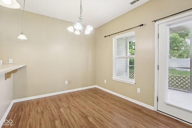 1138 Topp Creek Dr, Indianapolis, IN 46214 - unfurnished dining area featuring wood finished floors, a chandelier, and vaulted ceiling