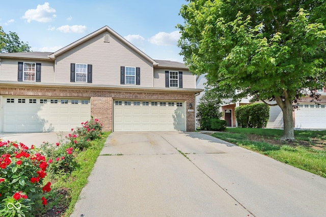 1138 Topp Creek Dr, Indianapolis, IN 46214 - view of front facade featuring brick siding, concrete driveway, and a garage
