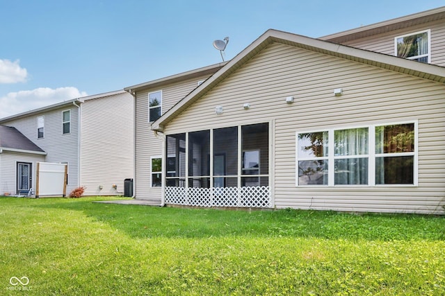 1138 Topp Creek Dr, Indianapolis, IN 46214 - rear view of house featuring a lawn and a sunroom