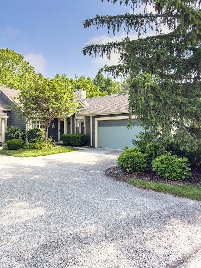 7470 Charrington Ct, Indianapolis, IN 46254 - view of front of property with concrete driveway, an attached garage, a chimney, and roof with shingles