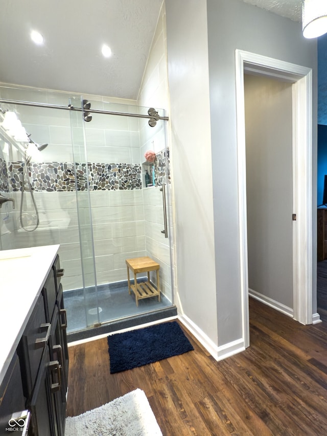 7470 Charrington Ct, Indianapolis, IN 46254 - bathroom with a stall shower, wood finished floors, vanity, and recessed lighting