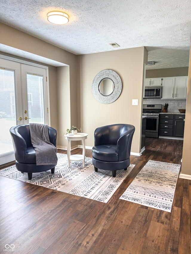 7470 Charrington Ct, Indianapolis, IN 46254 - living area featuring dark wood-type flooring, french doors, and a textured ceiling