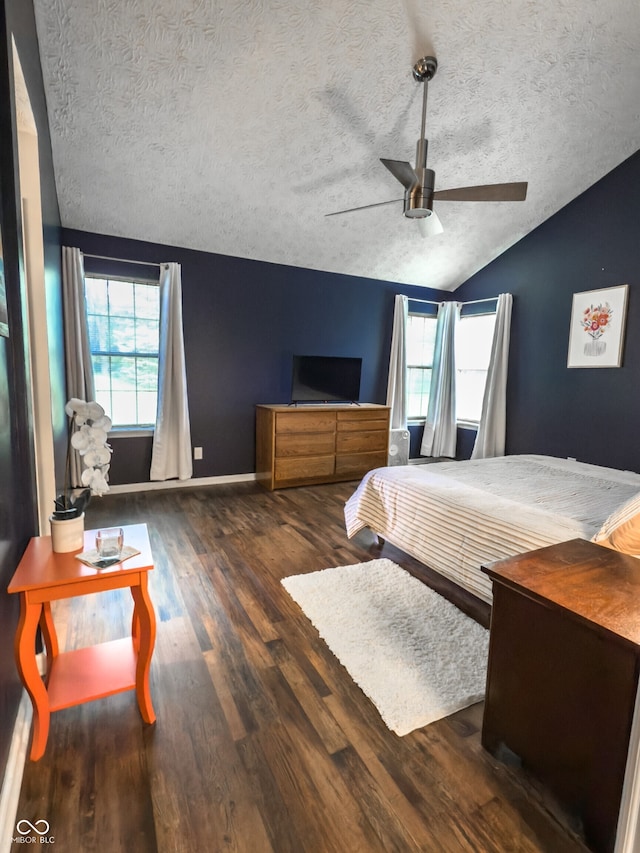 7470 Charrington Ct, Indianapolis, IN 46254 - bedroom featuring a textured ceiling, lofted ceiling, wood finished floors, and a ceiling fan