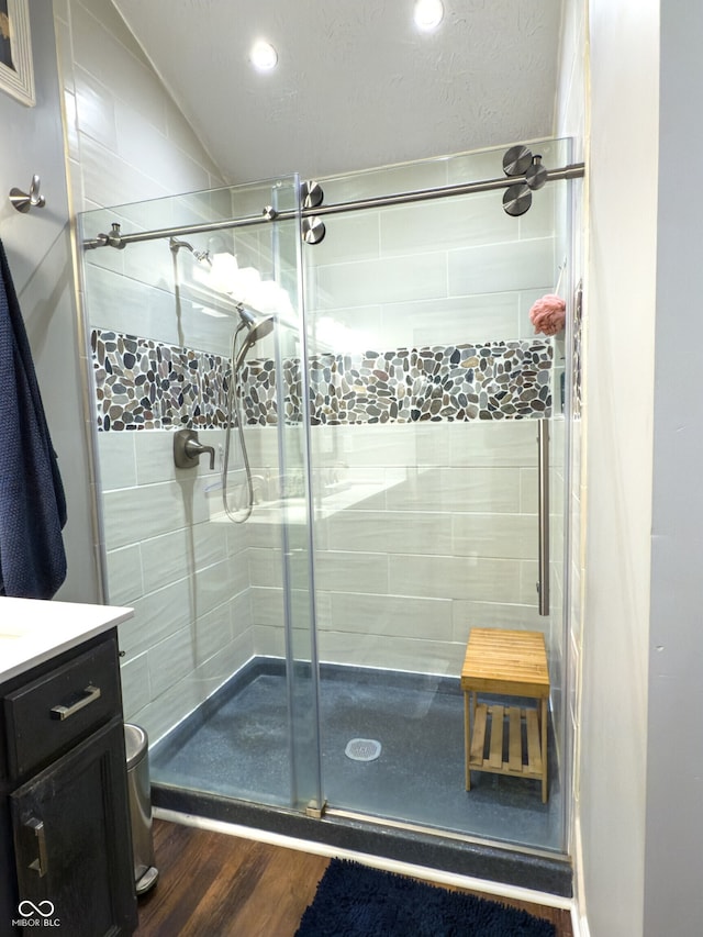 7470 Charrington Ct, Indianapolis, IN 46254 - full bath featuring a shower stall, wood finished floors, vanity, recessed lighting, and lofted ceiling