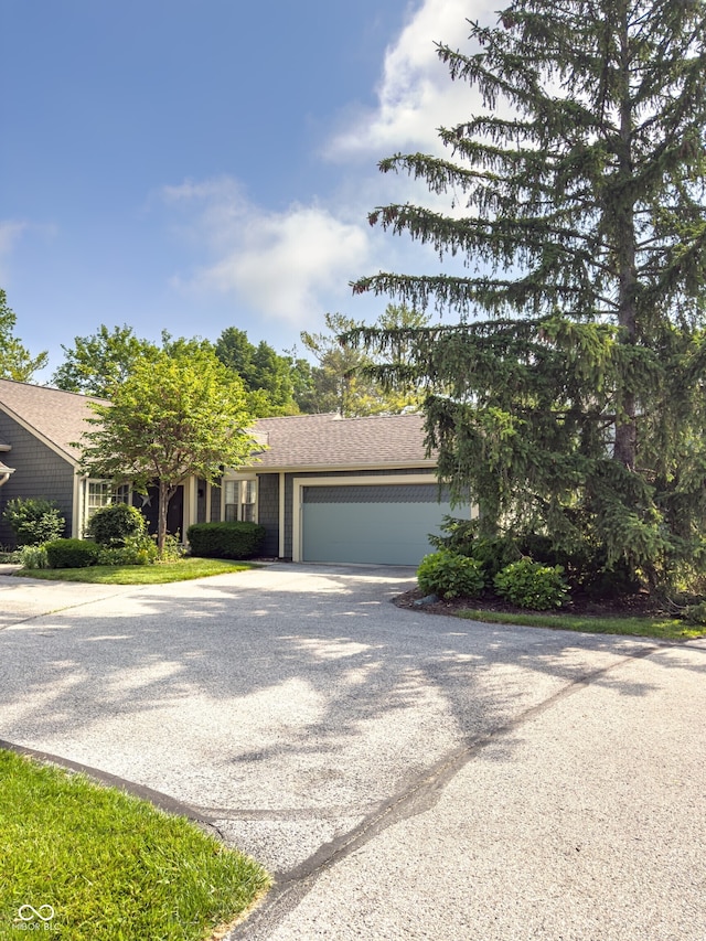7470 Charrington Ct, Indianapolis, IN 46254 - obstructed view of property with concrete driveway and an attached garage