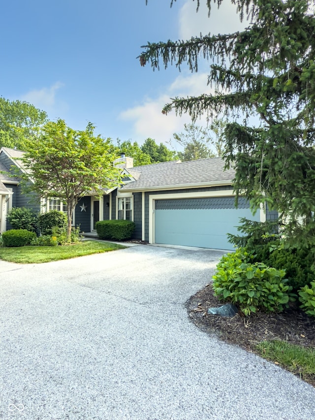7470 Charrington Ct, Indianapolis, IN 46254 - view of front of house with driveway, an attached garage, and a chimney