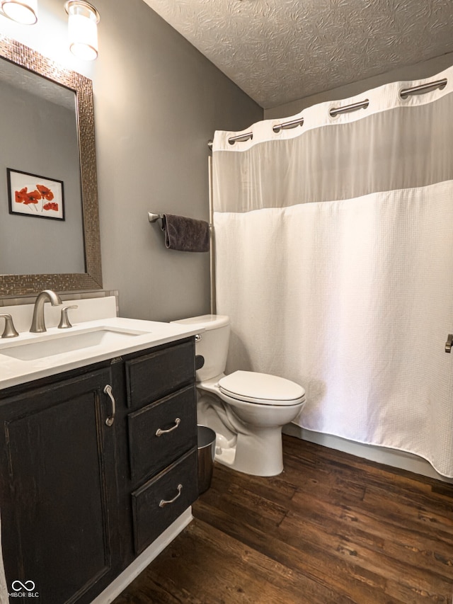 7470 Charrington Ct, Indianapolis, IN 46254 - full bathroom with wood finished floors, vanity, a textured ceiling, and curtained shower