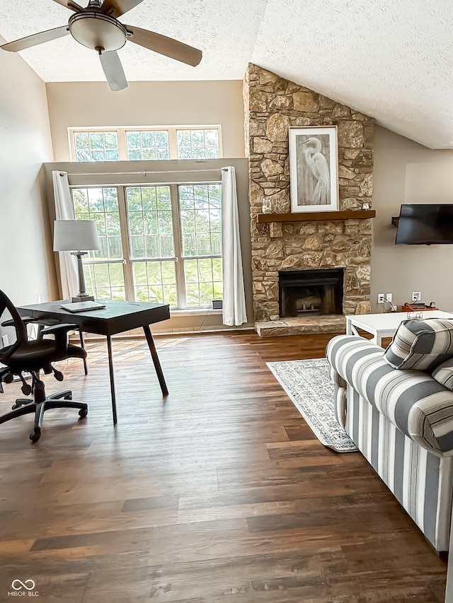 7470 Charrington Ct, Indianapolis, IN 46254 - living room with lofted ceiling, a textured ceiling, a ceiling fan, wood finished floors, and a fireplace
