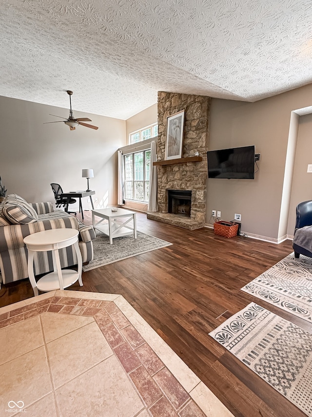 7470 Charrington Ct, Indianapolis, IN 46254 - living area with a textured ceiling, a fireplace, ceiling fan, and wood finished floors