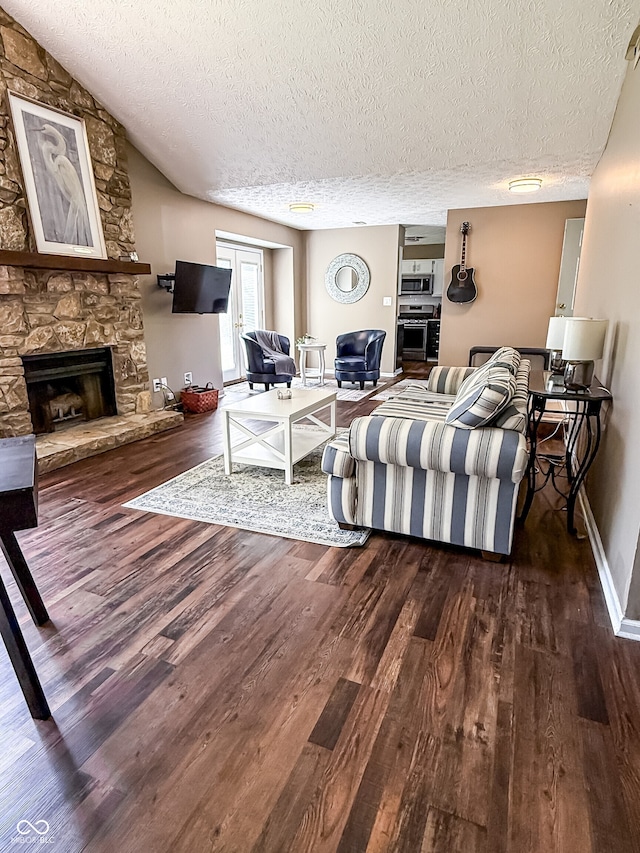 7470 Charrington Ct, Indianapolis, IN 46254 - living room with dark wood-type flooring, a textured ceiling, and a stone fireplace