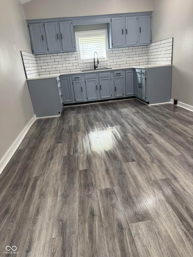 1006 Hurricane St, Franklin, IN 46131 - kitchen featuring dark wood-style floors, backsplash, light countertops, and blue cabinets