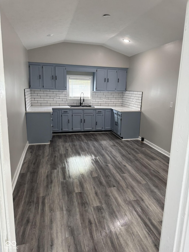 1006 Hurricane St, Franklin, IN 46131 - kitchen featuring vaulted ceiling, light countertops, dark wood-style flooring, and backsplash