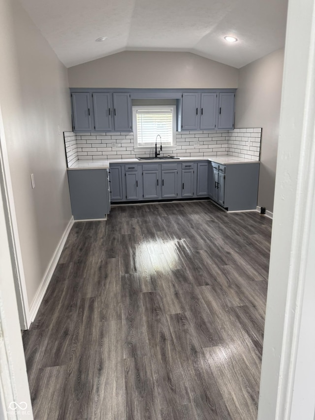 1006 Hurricane St, Franklin, IN 46131 - kitchen with light countertops, dark wood-style floors, vaulted ceiling, and backsplash