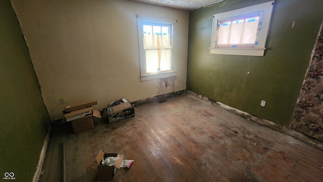 2157 Sugar Grove Ave, Indianapolis, IN 46202 - unfurnished room with hardwood / wood-style floors, healthy amount of natural light, and a textured ceiling