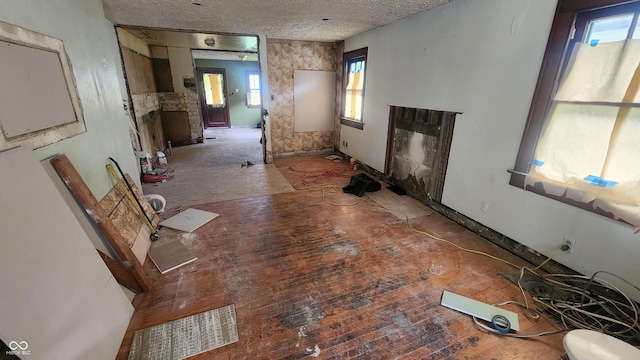 2157 Sugar Grove Ave, Indianapolis, IN 46202 - unfurnished living room featuring a textured ceiling and baseboards